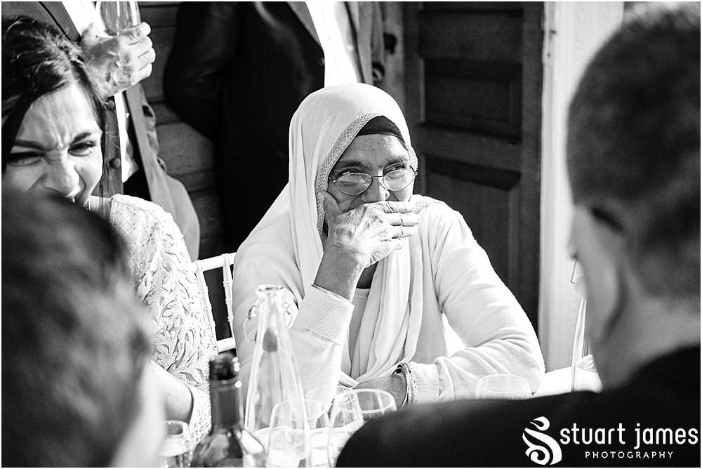 Wedding Guests listening to speech at Davenport House in Shropshire by Davenport House Wedding Photographers Stuart James