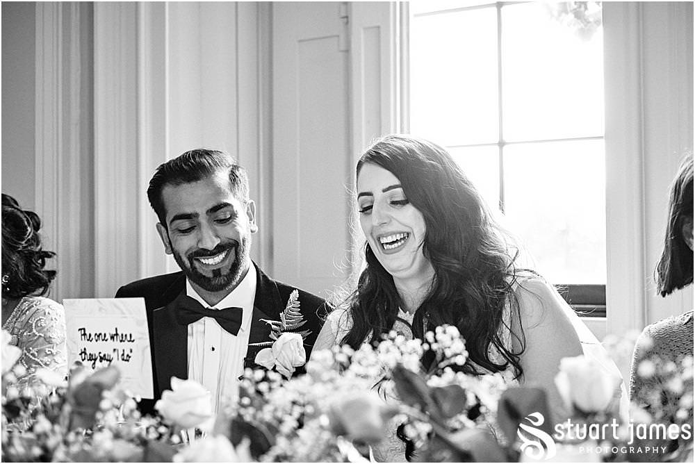 Bride and Groom laughing at Best Mans speech at Davenport House in Shropshire by Davenport House Wedding Photographers Stuart James