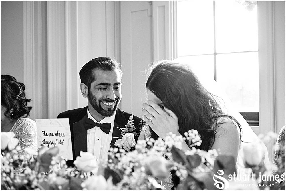 Bride and Groom laughing at Best mans speech at Davenport House in Shropshire by Davenport House Wedding Photographers Stuart James