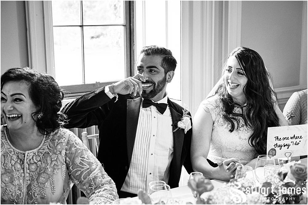 Bride and Groom listening to Best Man's speech at Davenport House in Shropshire by Davenport House Wedding Photographers Stuart James