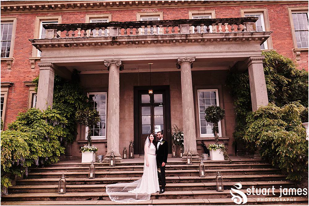 Bride and Groom pose for outside portrait photo on the steps at Davenport House in Shropshire by Davenport House Wedding Photographers Stuart James