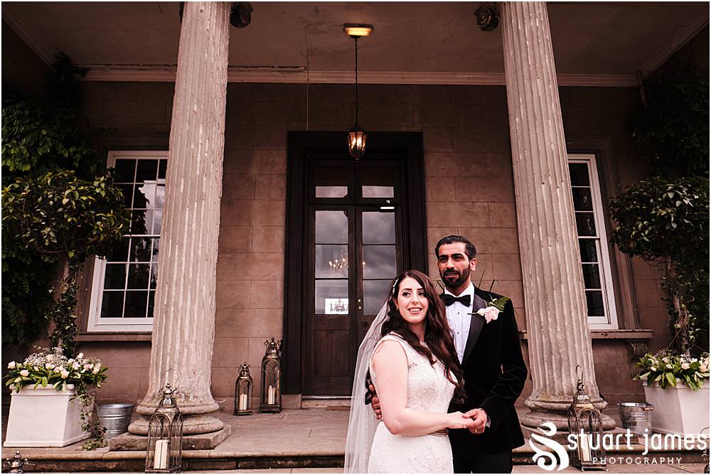 Bride and Groom pose for outside portrait photo on the steps at Davenport House in Shropshire by Davenport House Wedding Photographers Stuart James