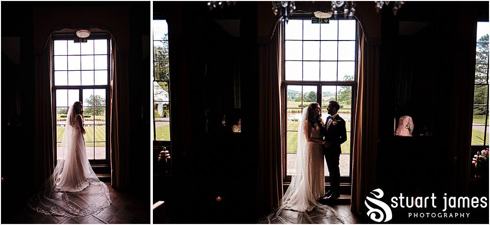 Bride and Groom pose for inside portrait photo infront of floor length window at Davenport House in Shropshire by Davenport House Wedding Photographers Stuart James