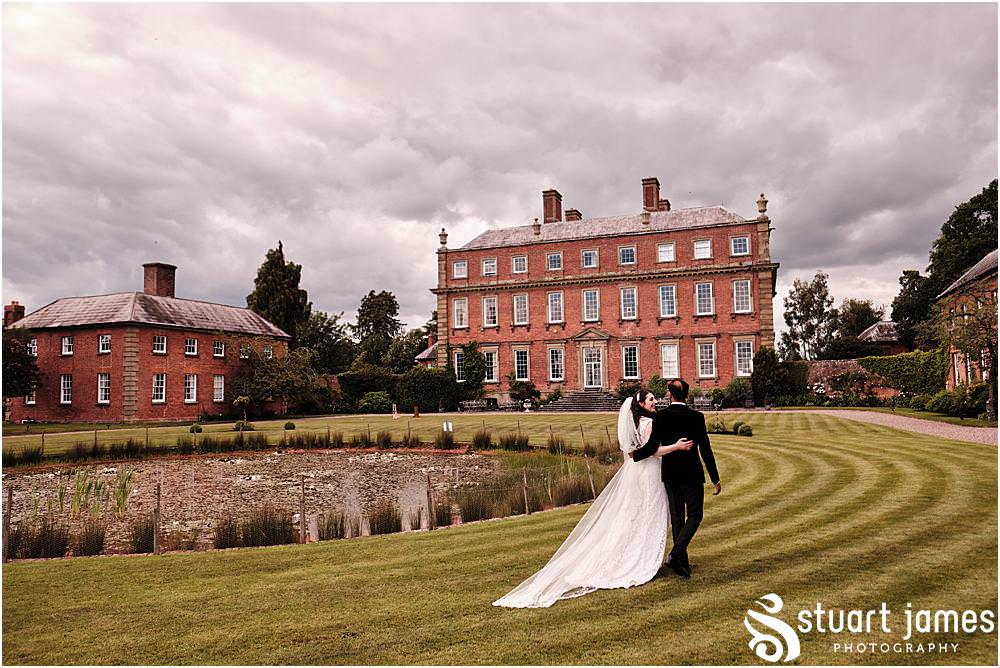 Bride and Groom pose for outside portrait in the gardens at Davenport House in Shropshire by Davenport House Wedding Photographers Stuart James