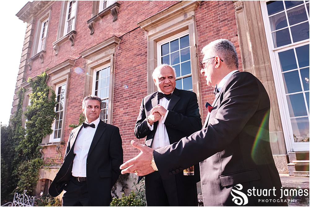 Wedding guests talk at Davenport House in Shropshire by Davenport House Wedding Photographers Stuart James