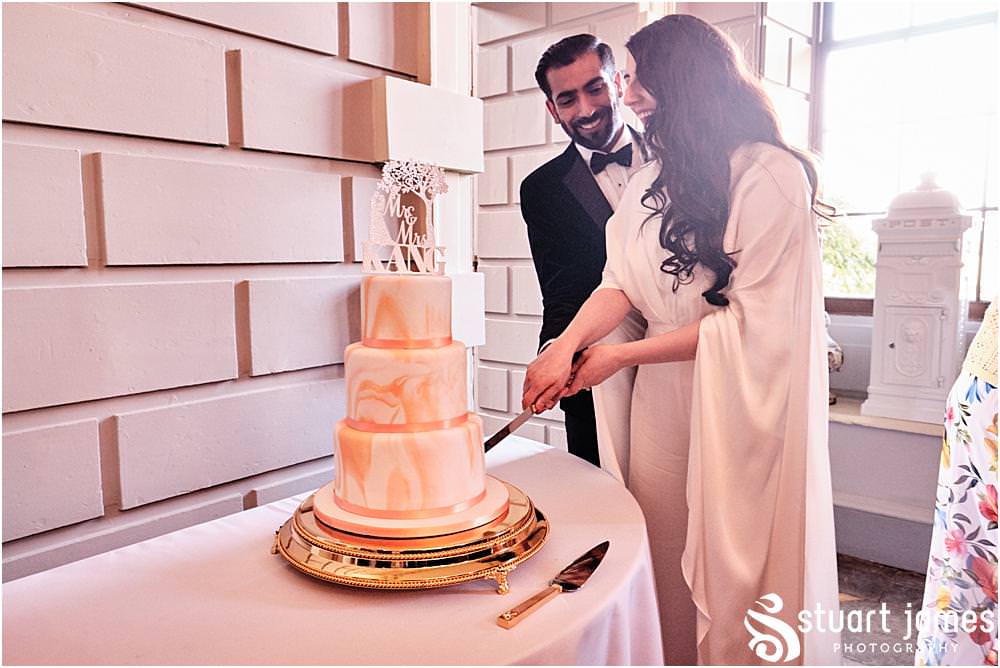 Bride and Groom cut their wedding cake at Davenport House in Shropshire by Davenport House Wedding Photographers Stuart James