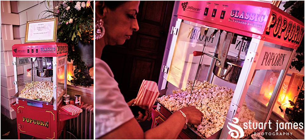 Wedding guests getting popcorn from the Popcorn making machine at Davenport House in Shropshire by Davenport House Wedding Photographers Stuart James