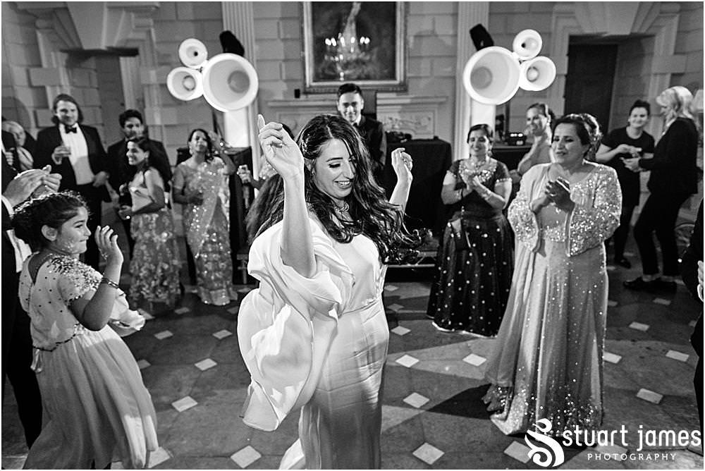 Bride and Wedding guests dancing at Davenport House in Shropshire by Davenport House Wedding Photographers Stuart James
