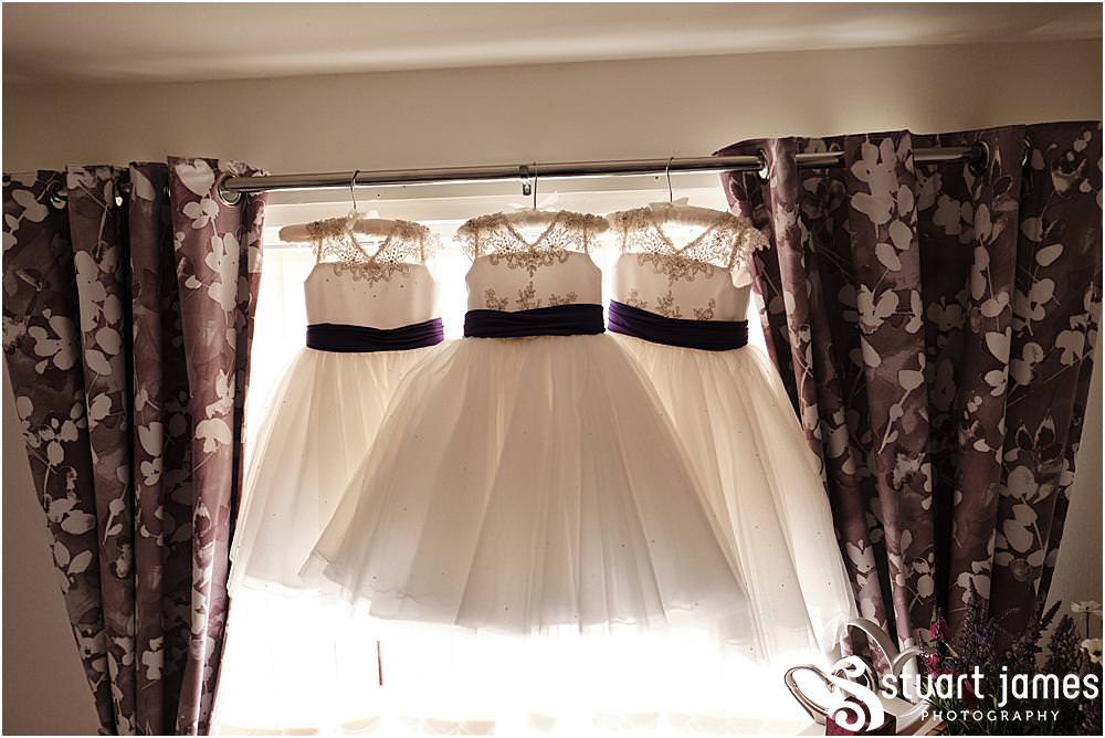 Flower girls dresses hanging in window before wedding at The Village Hotel, Walsall, photo by Stuart James Photography