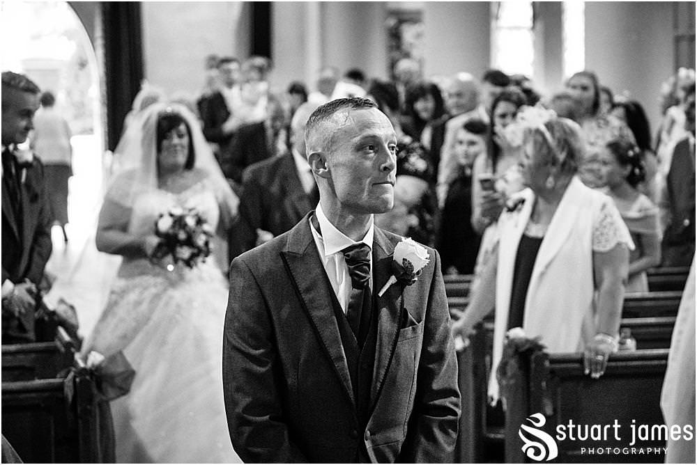 Groom waits for Bride at Holy Trinity Church in Eccleshall, photo by Stuart James Photography at Holy Trinity Church, Eccleshall