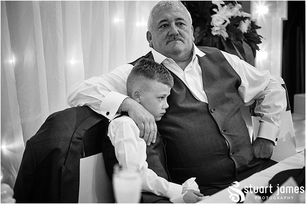 Father of the Bride sits with Page boy at The Village Hotel in Walsall by Walsall Wedding Photographer Stuart James