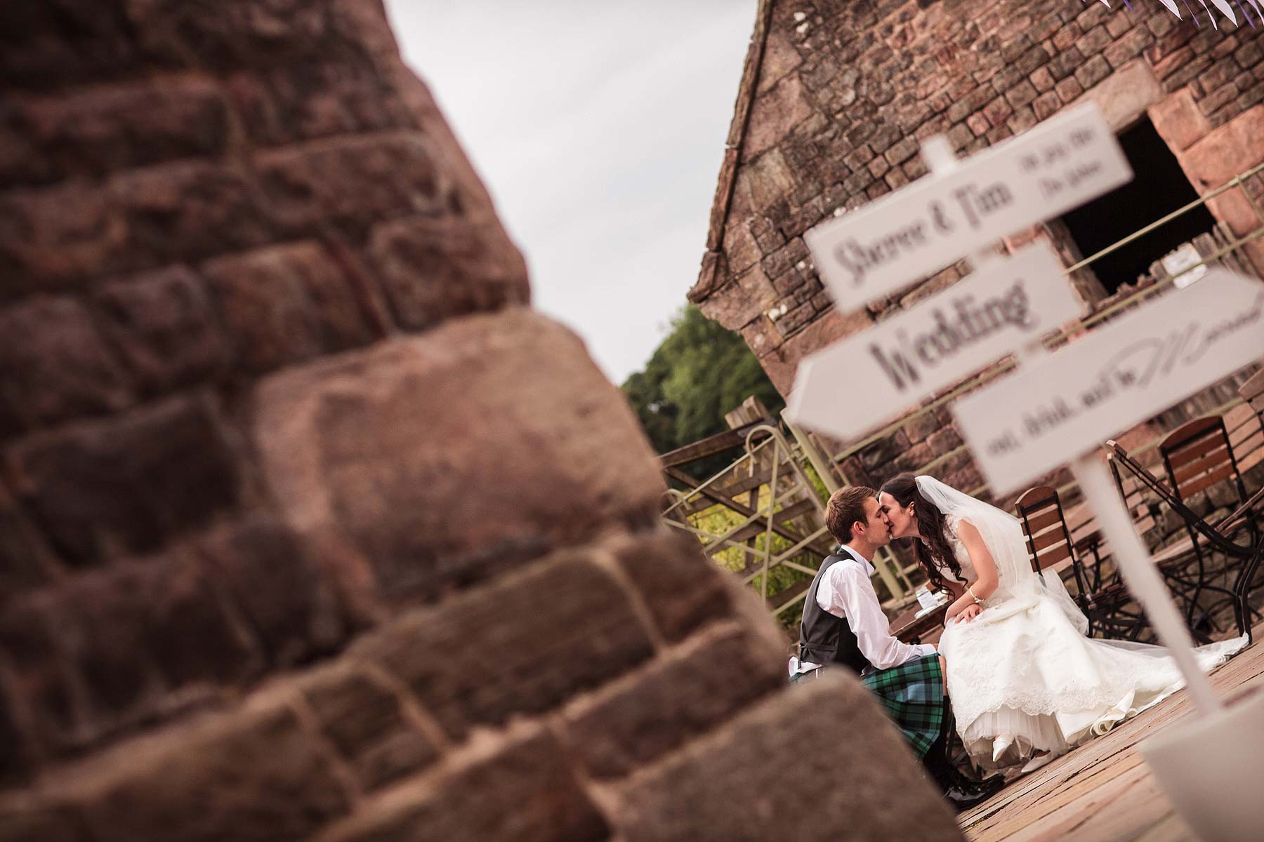 Evocative capture of a fleeting moment as the bride and groom escape for a brief interlude together at The Ashes in Endon by Leek Documentary Wedding Photographer Stuart James
