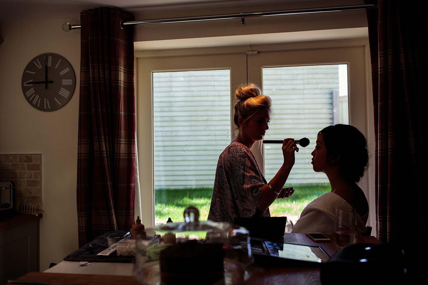 Creative candid photography captures the excitement of the wedding morning during bridal makeup and hairstyling at The Ashes in Endon by Leek Documentary Wedding Photographer Stuart James