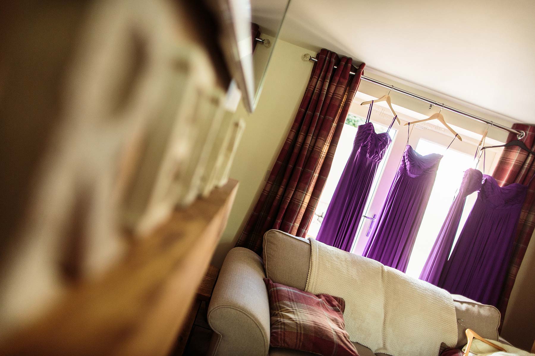 Creative candid photography captures the excitement of the wedding morning during bridal makeup and hairstyling at The Ashes in Endon by Leek Documentary Wedding Photographer Stuart James