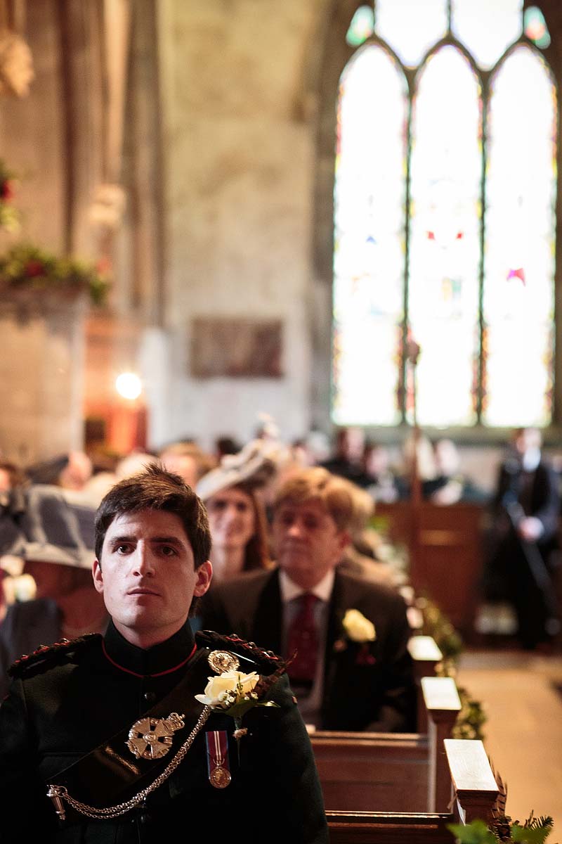 Nervous groom awaiting the arrival of his bride at All Saints Church in Sandon by Stafford Recommended Wedding Photographer Stuart James