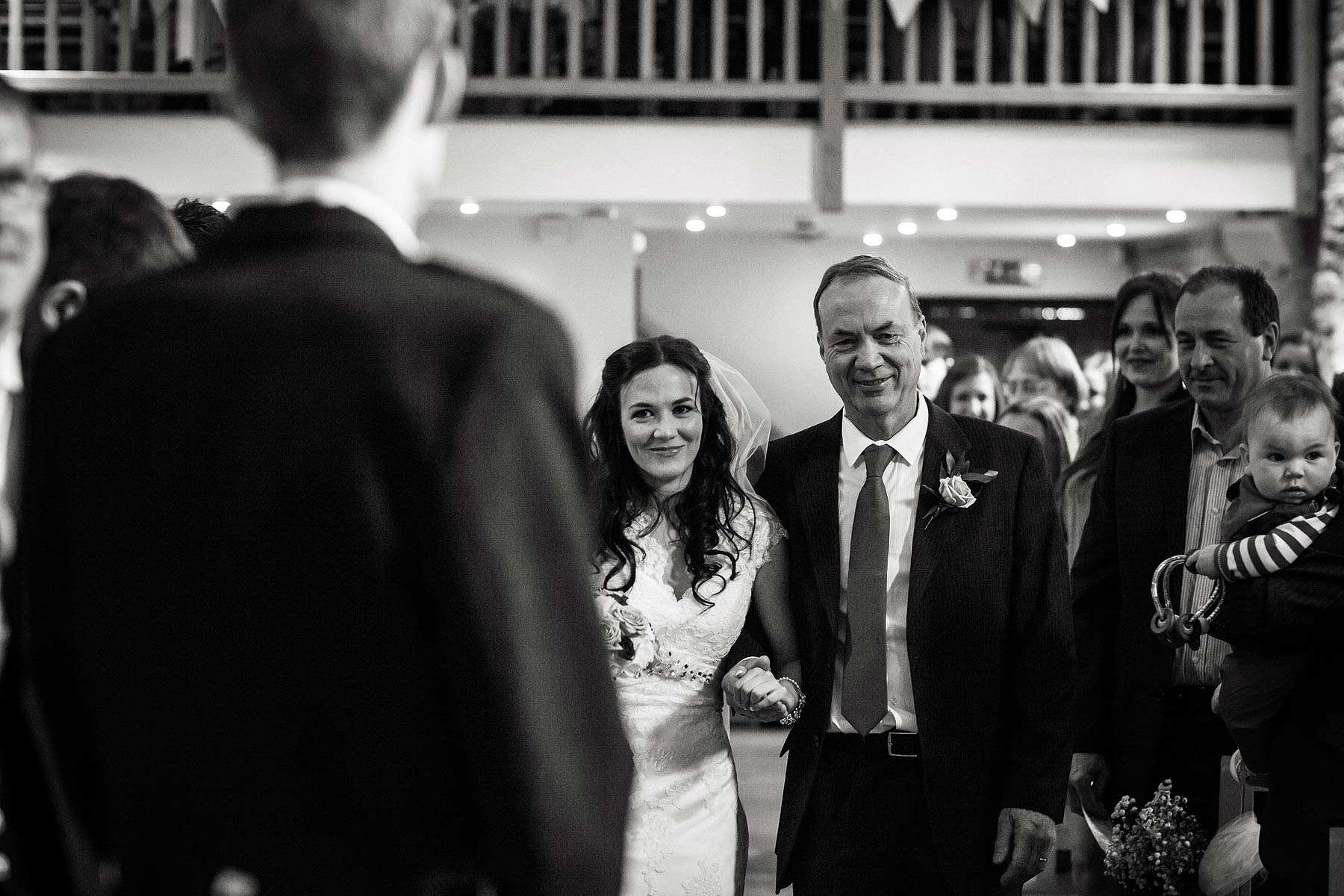 Unobtrusive creative wedding photography story of the beautiful ceremony in the barn at The Ashes in Endon by Leek Documentary Wedding Photographer Stuart James