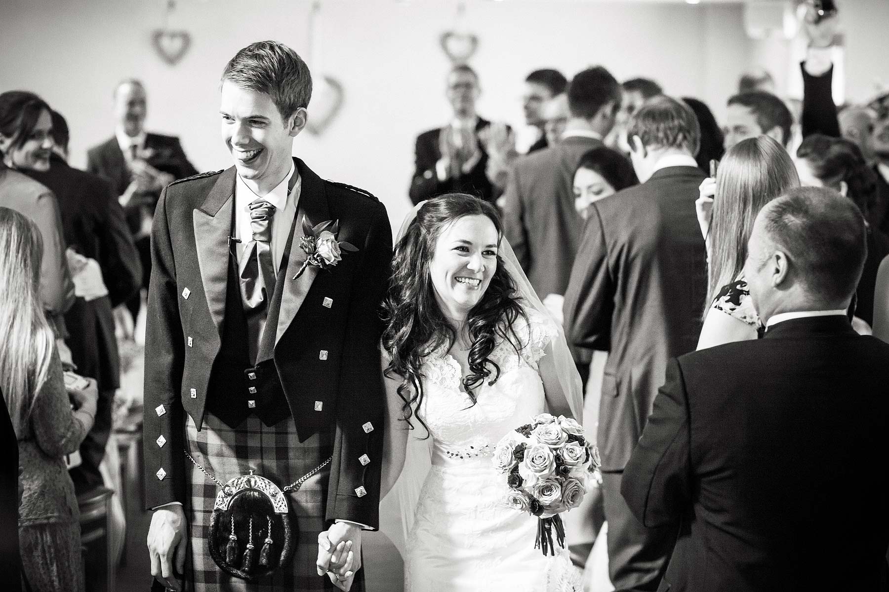 Unobtrusive capturing the wedding story as the Bride and Groom exchange vows in the barn at The Ashes in Endon by Leek Documentary Wedding Photographer Stuart James