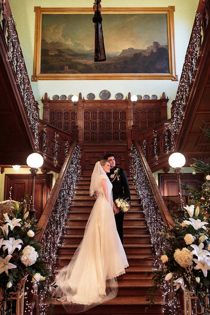 Contemporary intimate portraits on the grand staircase at Sandon Hall in Stafford by Stafford Documentary Wedding Photographer Stuart James