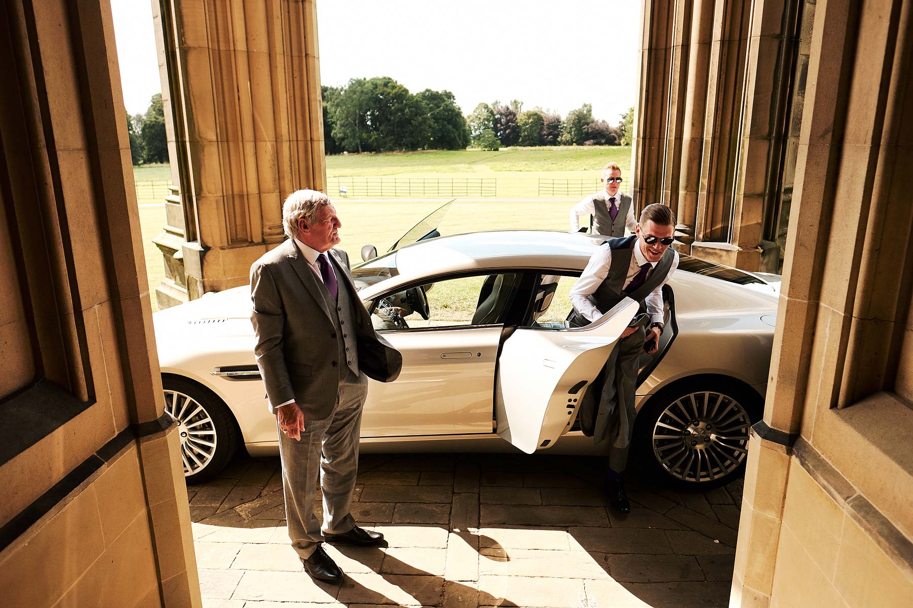 Arriving in style for the wedding at Allerton Castle in Yorkshire by Documentary Wedding Photographer Stuart James