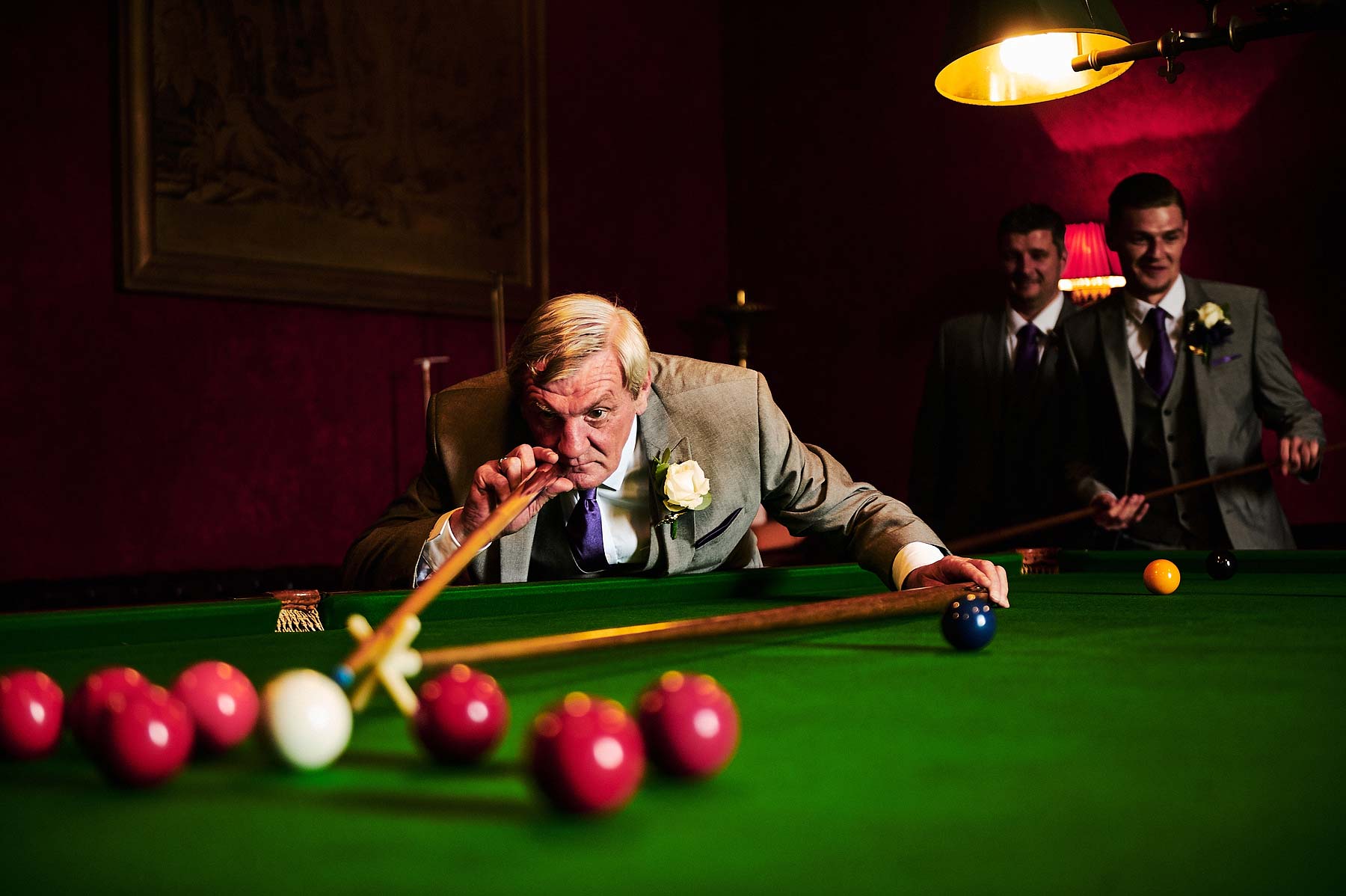Creative fun portraits with the groomsmen in the billiards room at Allerton Castle in Yorkshire by Documentary Wedding Photographer Stuart James