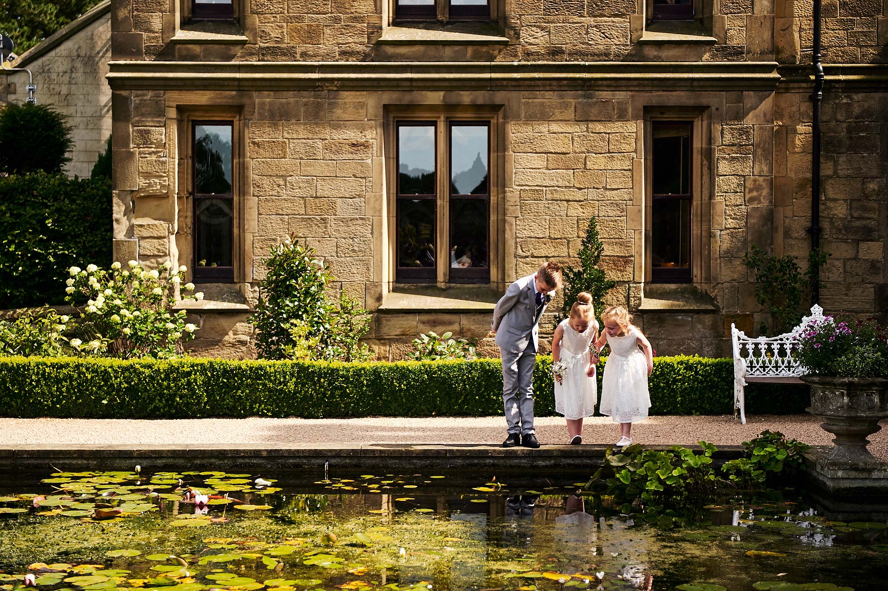 Creative candid photographs as the guests enjoy the drinks reception in the gardens at Allerton Castle in Yorkshire by Documentary Wedding Photographer Stuart James