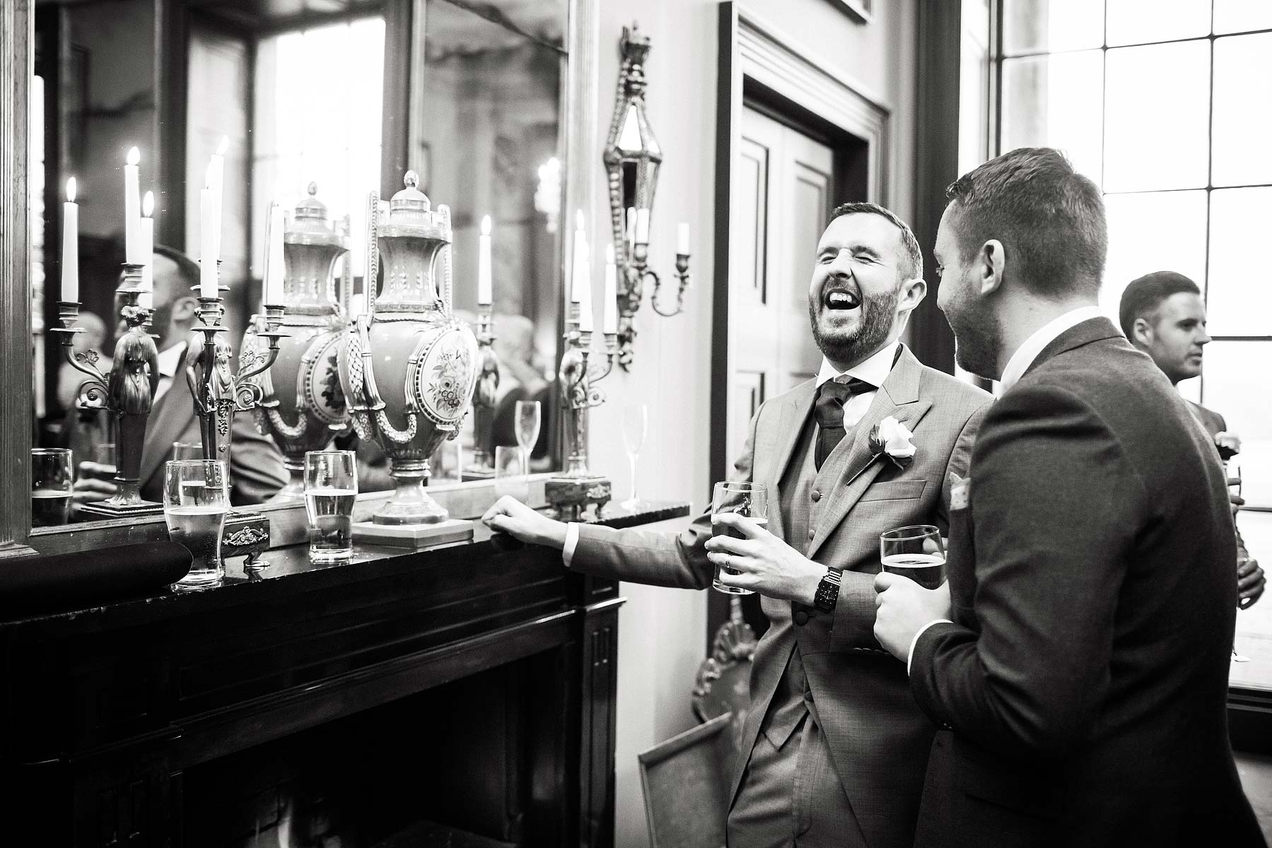 Candid photographs of guests enjoying drinks reception at Chillington Hall in Brewood by Documentary Wedding Photographer Stuart James