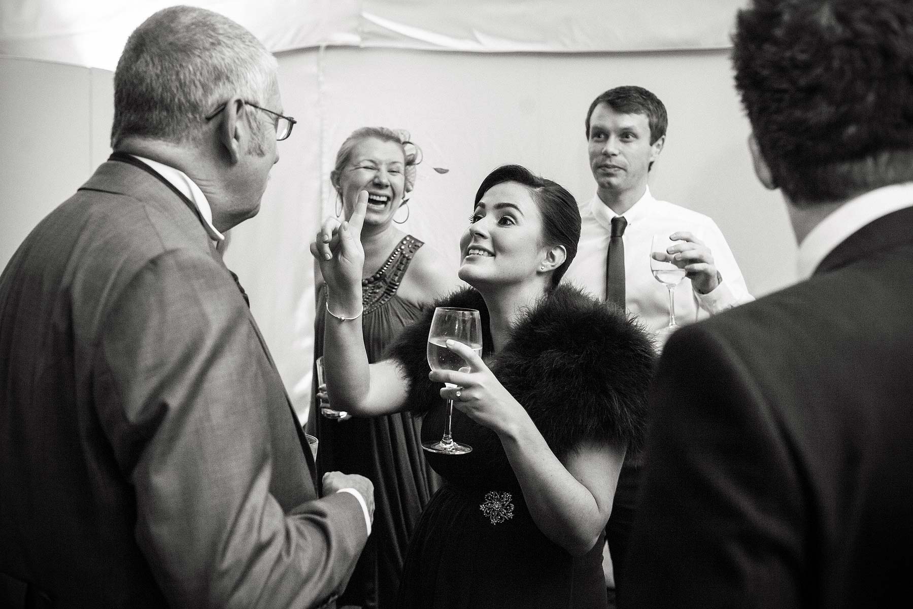 Candid photographs of guests enjoying evening reception at Chillington Hall in Brewood by Reportage Wedding Photographer Stuart James