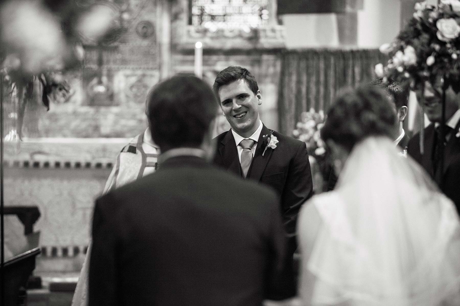 Reportage photographs capture the emotion on the grooms face as his bride walks down the aisle at St Chads Church in Pattingham by Pattingham Wedding Photographer Stuart James