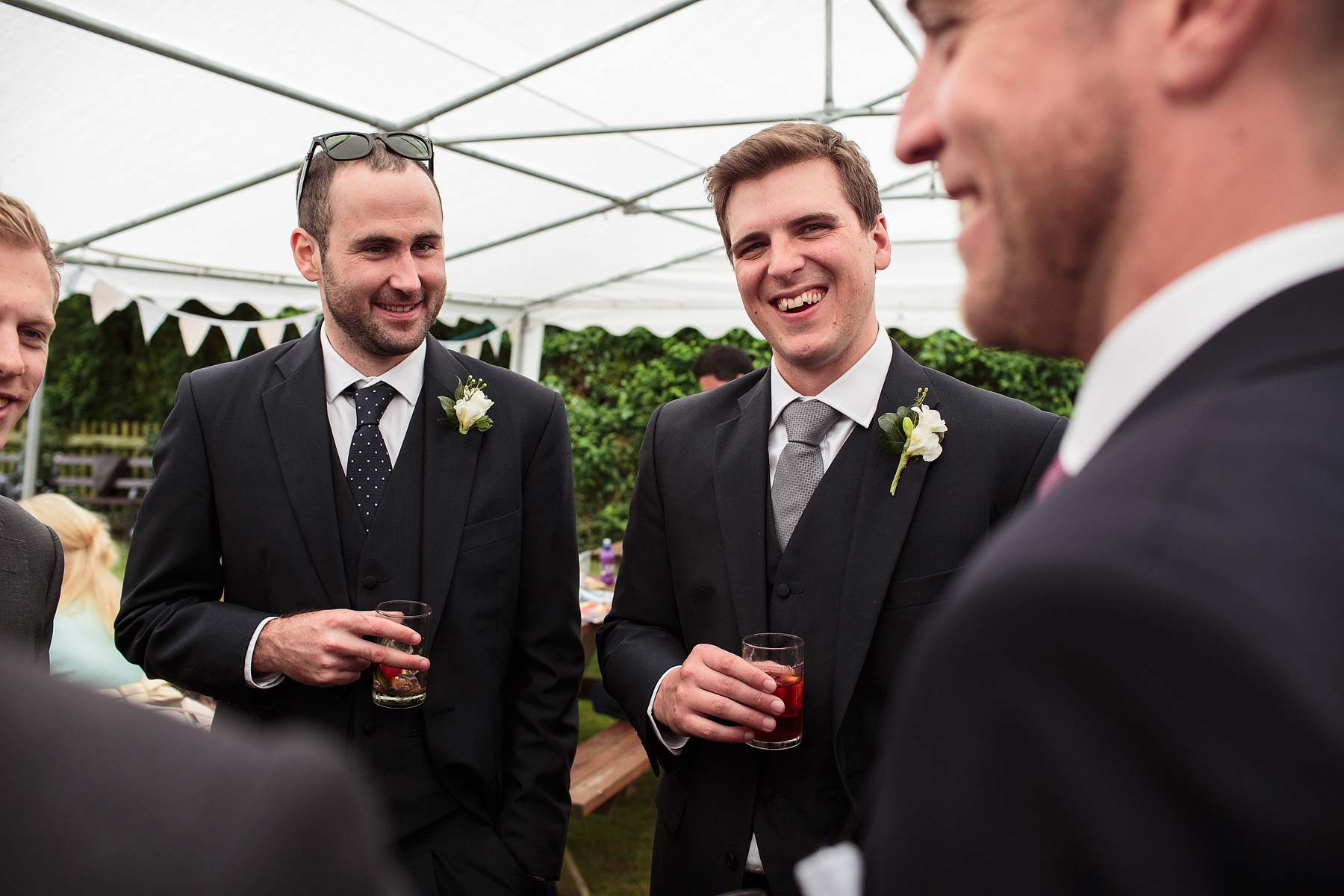 Candid photographs that capture the fun and frolics of the drinks reception and lawn games at Hundred House Hotel in Telford by Telford Documentary Wedding Photographer Stuart James