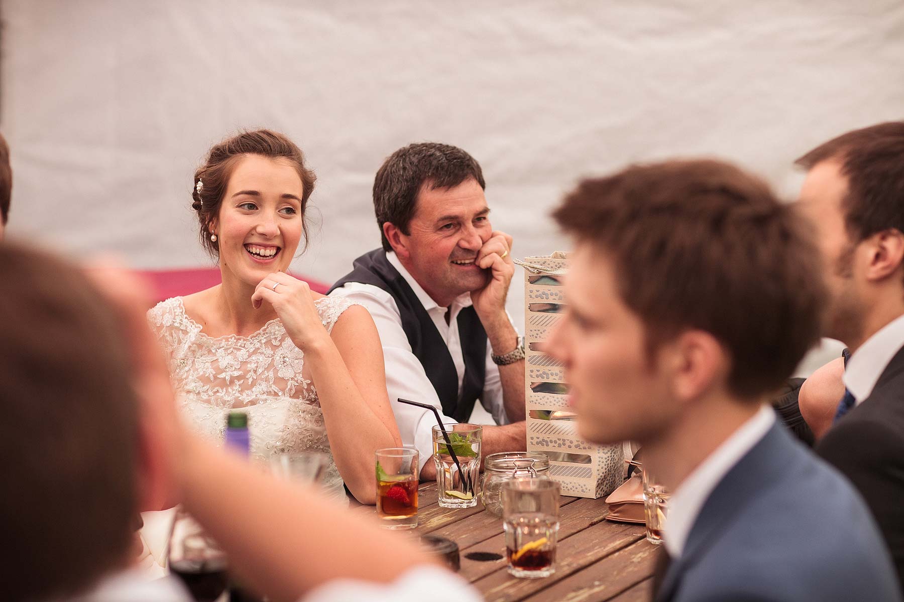 Candid photographs that show the fun of the evening reception in the Tithe Barn at Hundred House Hotel in Norton by Shropshire Documentary Wedding Photographer Stuart James