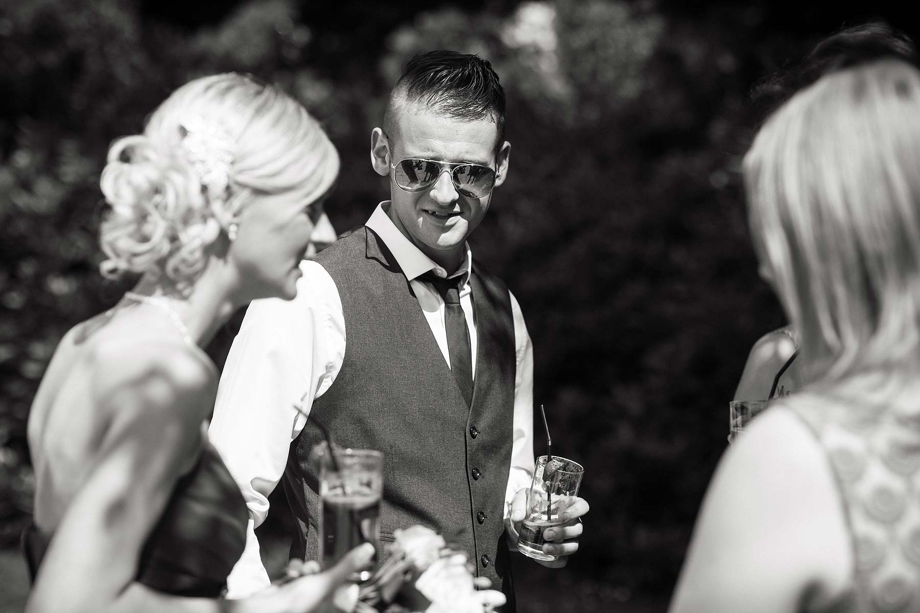 Guests enjoying the beautiful setting at Somerford Hall in Brewood by Candid Wedding Photographer Stuart James