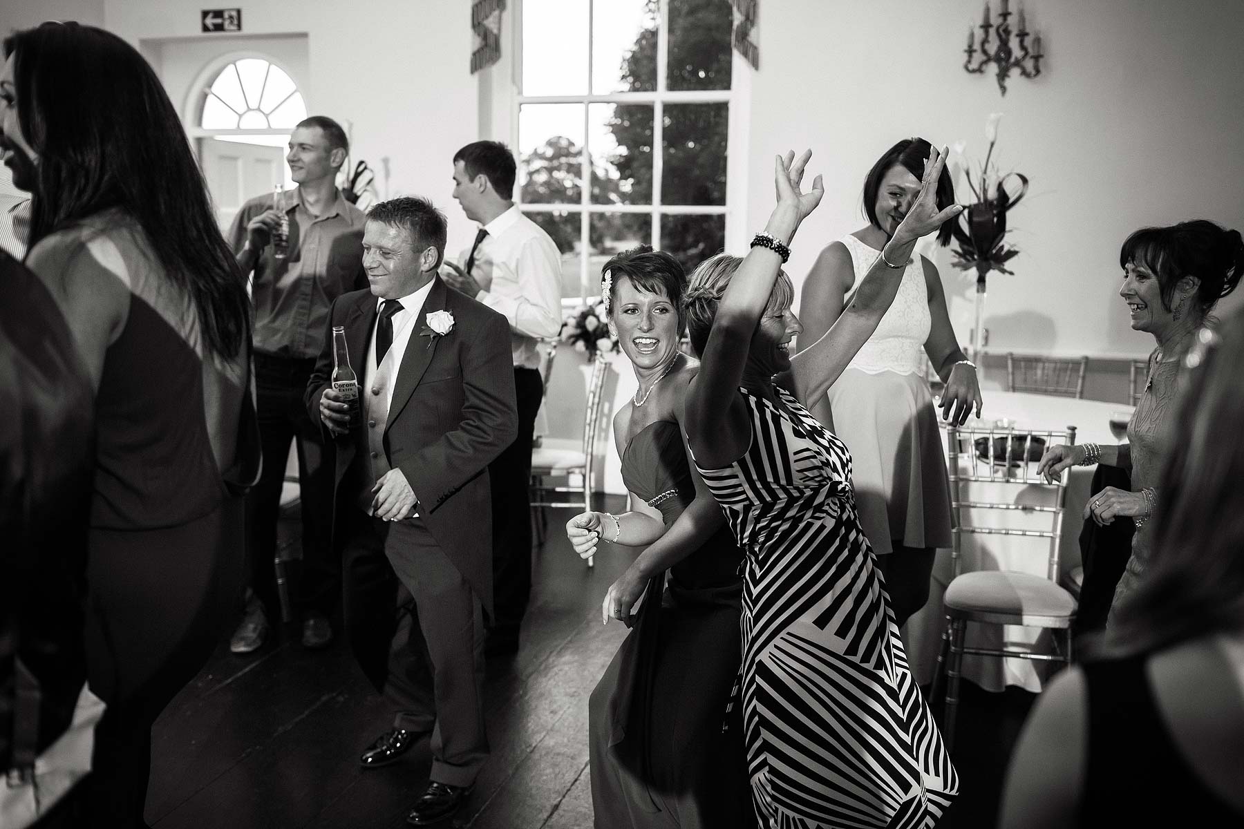 Creating brilliant photos of evening party at Somerford Hall in Brewood by Documentary Wedding Photographers Stuart James
