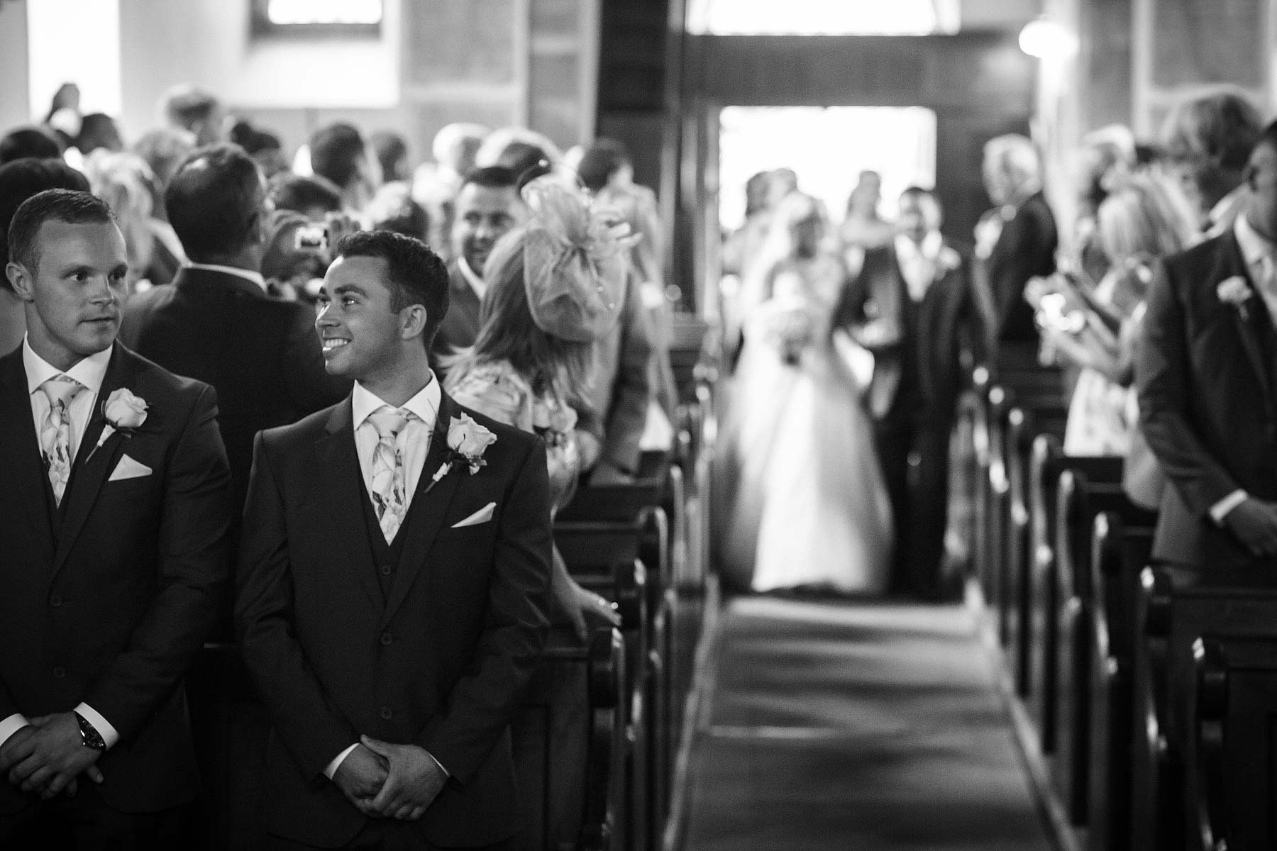 Beautiful reactions and glimpses between couple during wedding ceremony at St Andrews Church Weston Park in Staffordshire by Documentary Wedding Photographer Stuart James