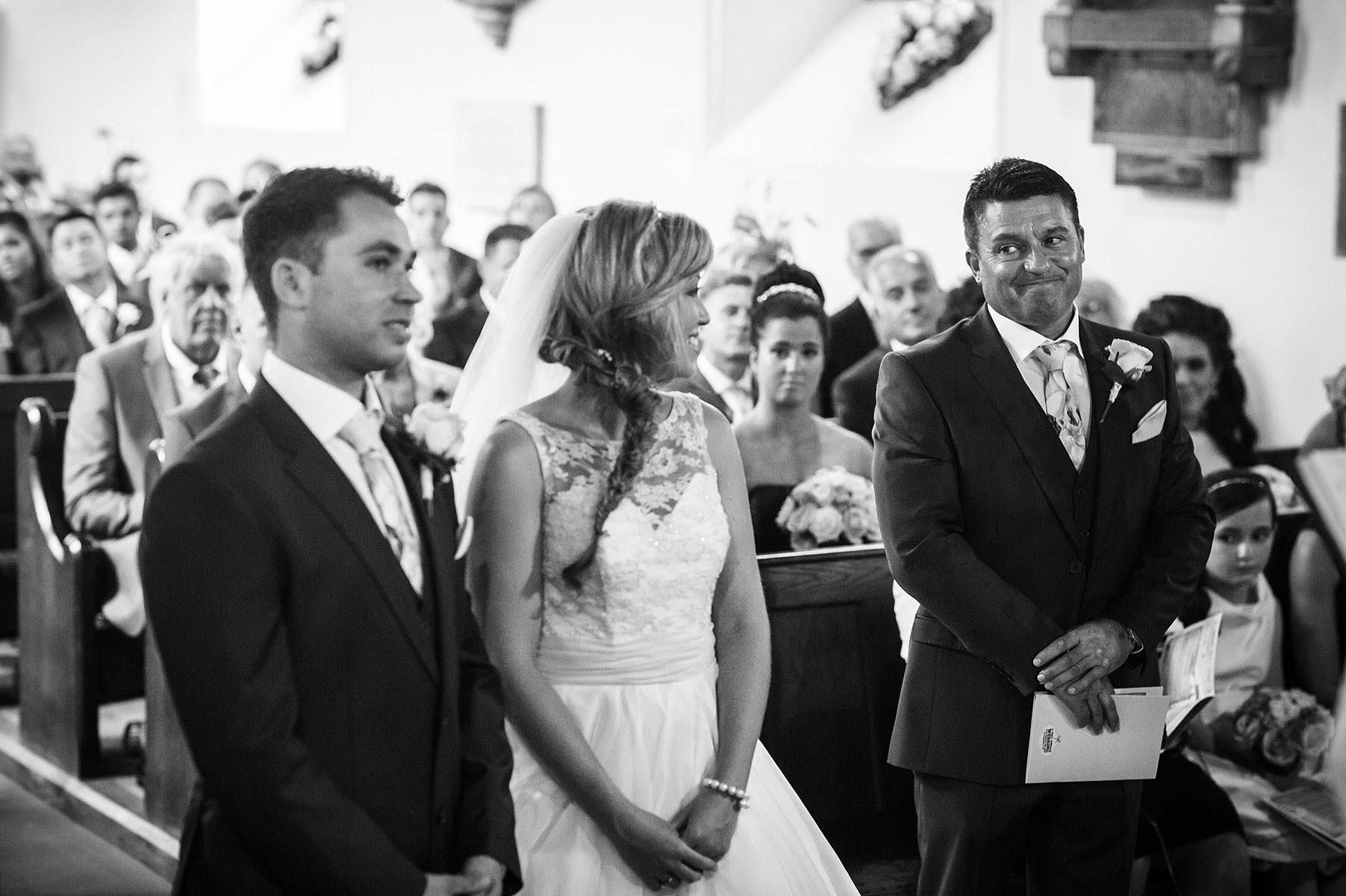 Beautiful reactions and glimpses between couple during wedding ceremony at St Andrews Church Weston Park in Staffordshire by Documentary Wedding Photographer Stuart James