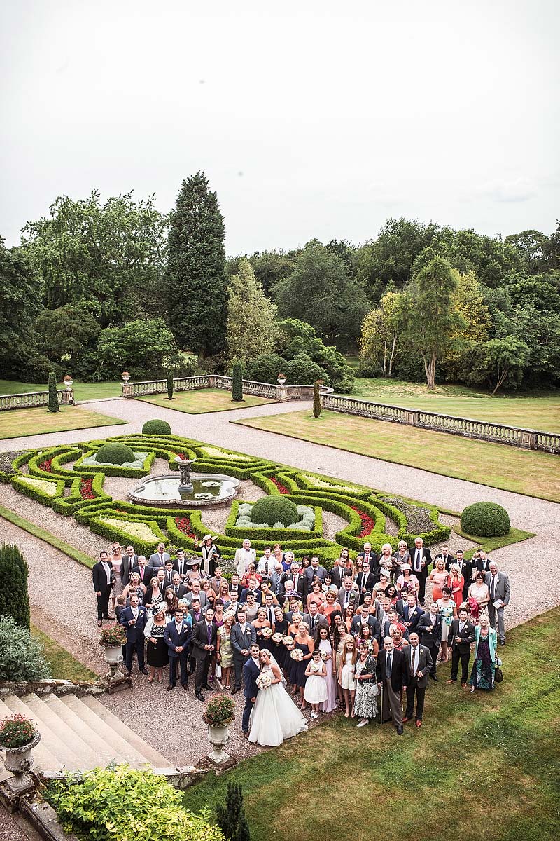 Big group photograph in Italian Gardens at Weston Park in Staffordshire by Documentary Wedding Photographer Stuart James