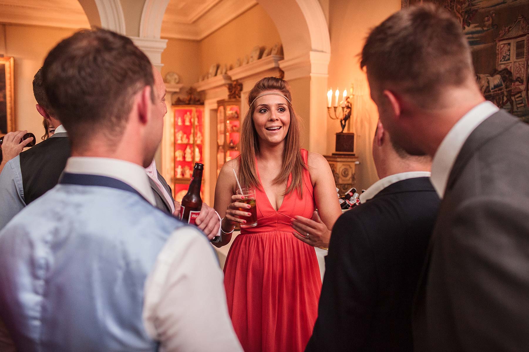 Capturing relaxed natural photographs of guests enjoying drinks reception on evening at Weston Park in Weston-under-Lizard by Staffordshire Wedding Photographer Stuart James