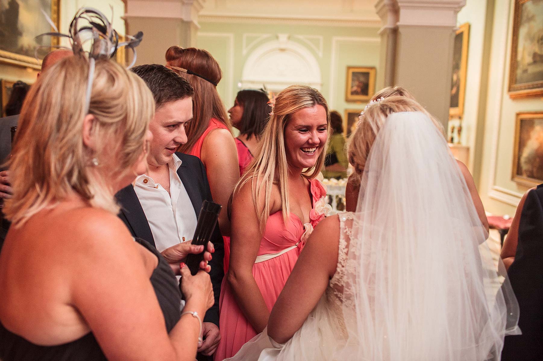 Candid photographs of guests enjoying evening reception at Weston Park in Weston-under-Lizard by Staffordshire Wedding Photographer Stuart James