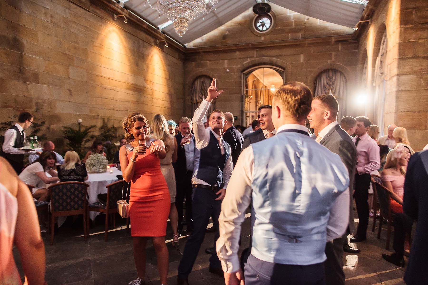 Reportage photographs of guests enjoying fantastic evenings reception at Weston Park in Weston-under-Lizard by Documentary Wedding Photographer Stuart James