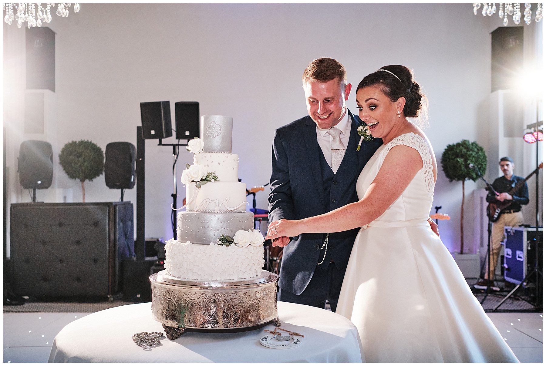 Cutting the brilliant cake from Design by Dawn at Hawkstone Hall in Shrewsbury by Documentary Wedding Photographer Stuart James